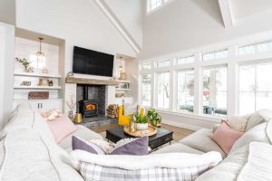 Modern Farmhouse Family Room With Transom Windows And A Wood Burning Stove